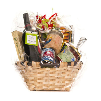 The basket's contents are Idiazabal cheese, palette, Mousse foie, txoriz, asparagus, organic Piquillo Peppers, Extra Virgin Olive Oil, Bonito from Getaria, "Tiles" from Tolosa, Rioja Alavesa wine, Txakolina from Getaria and Cavav